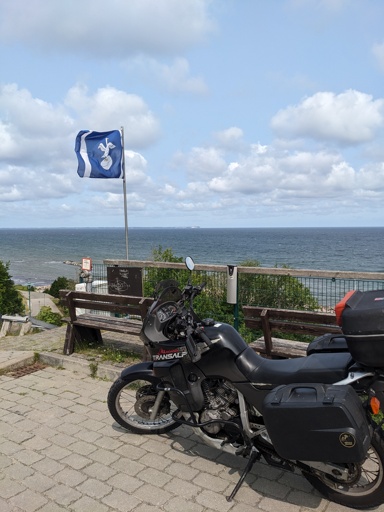a honda transalp motorcycle next to the flag of the island Rügen