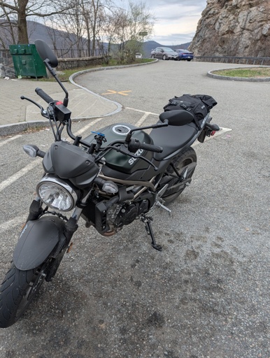 dark green standard motorcycle parked